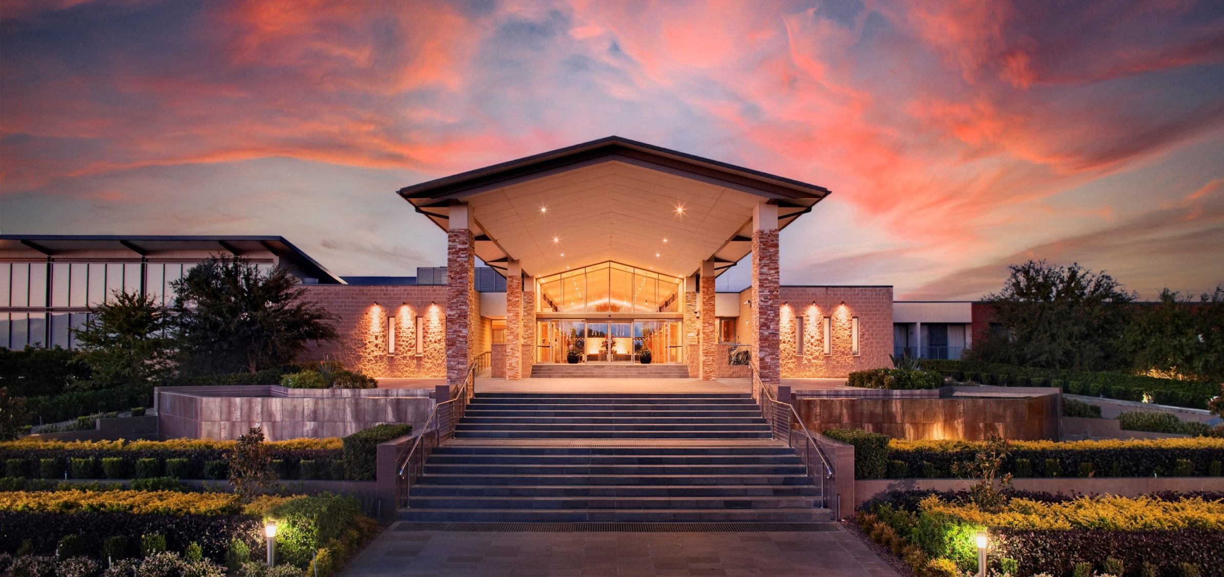 Sunset illuminating the main entrance of a picturesque resort.
