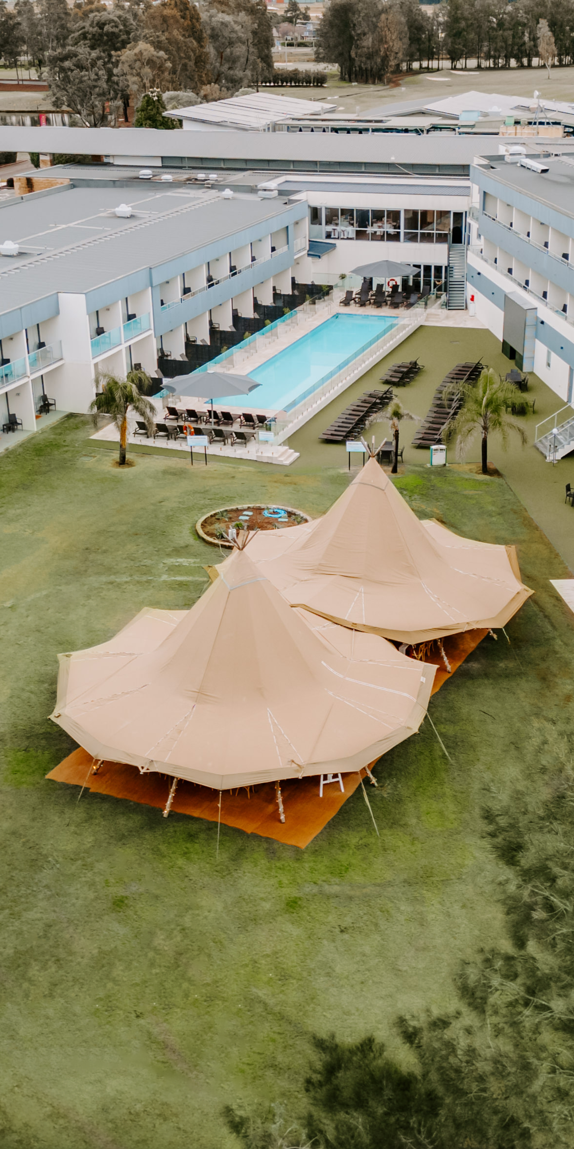 Wedding marquee tents set up near the Haven pool at Rydges Resort Hunter Valley